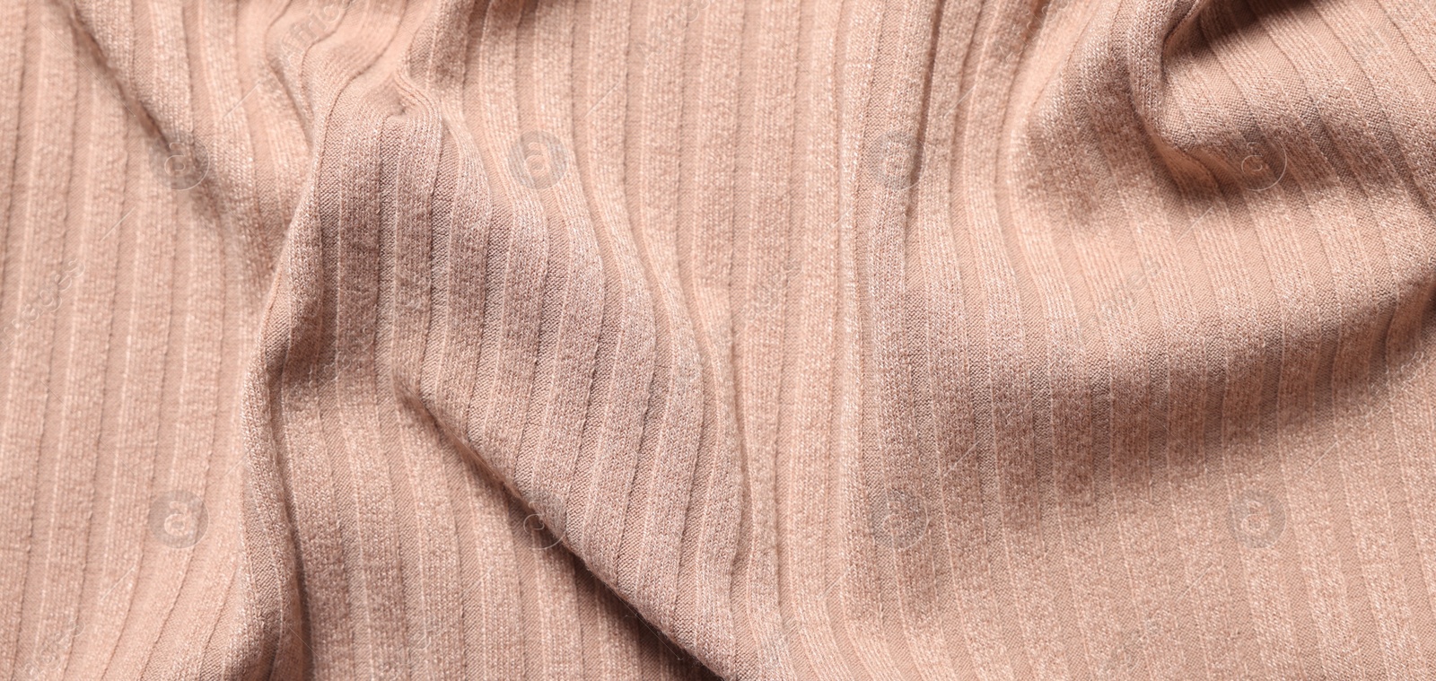 Photo of Texture of beige crumpled fabric as background, top view