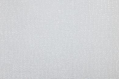 Stylish light grey wallpaper as background, closeup view