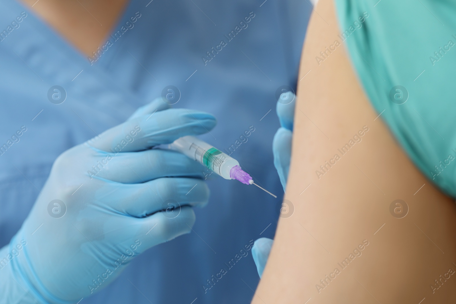 Photo of Doctor giving hepatitis vaccine to patient, closeup