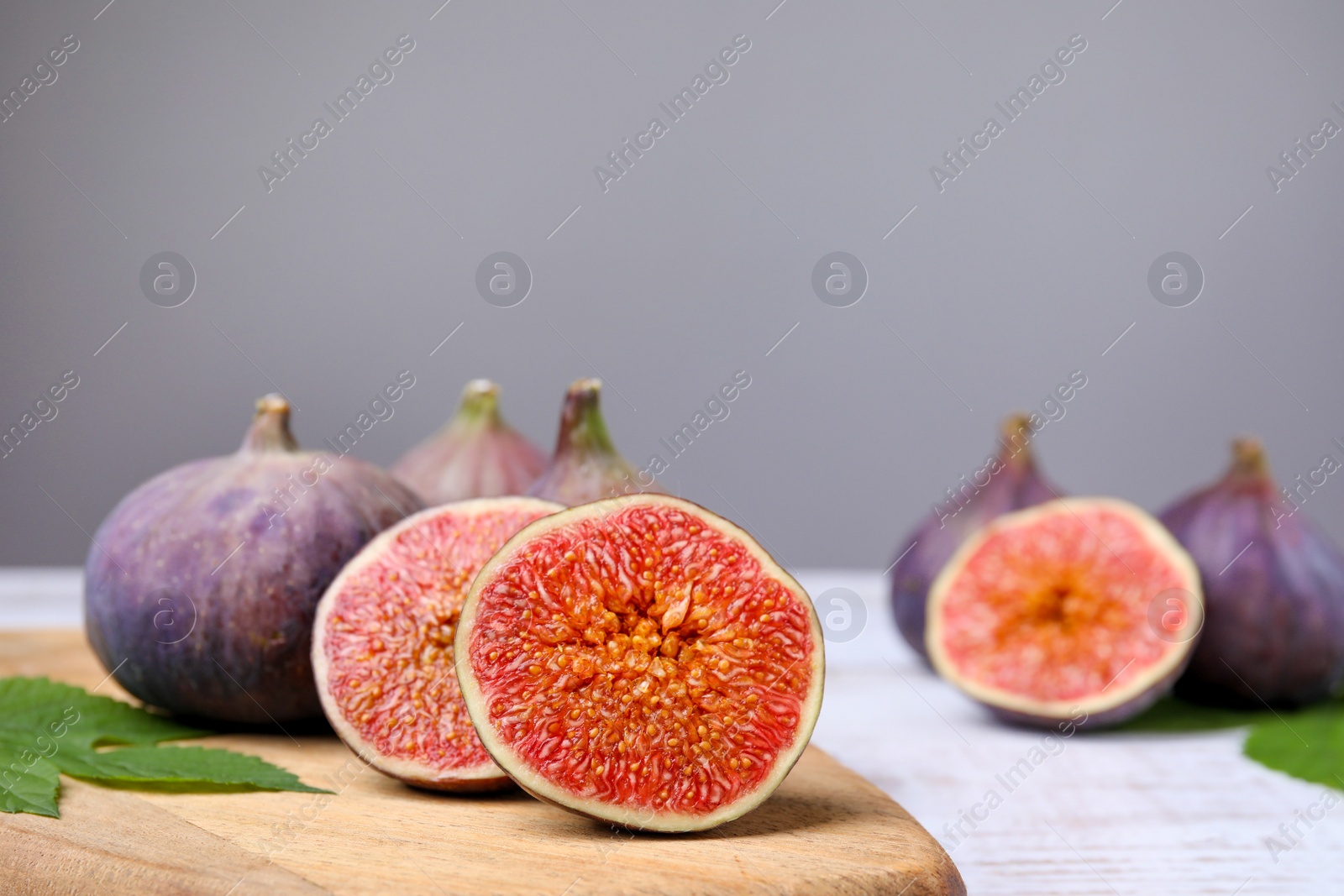 Photo of Fresh ripe figs on white wooden table