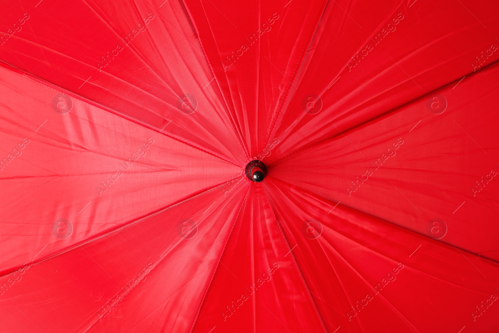 Image of Bright red umbrella as background, closeup view