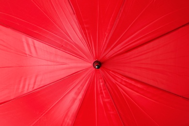 Image of Bright red umbrella as background, closeup view