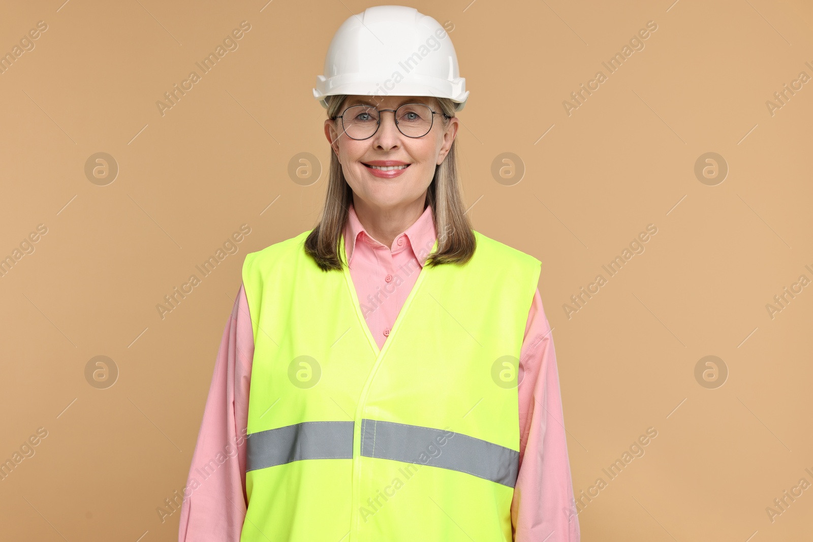 Photo of Portrait of architect in hard hat on beige background