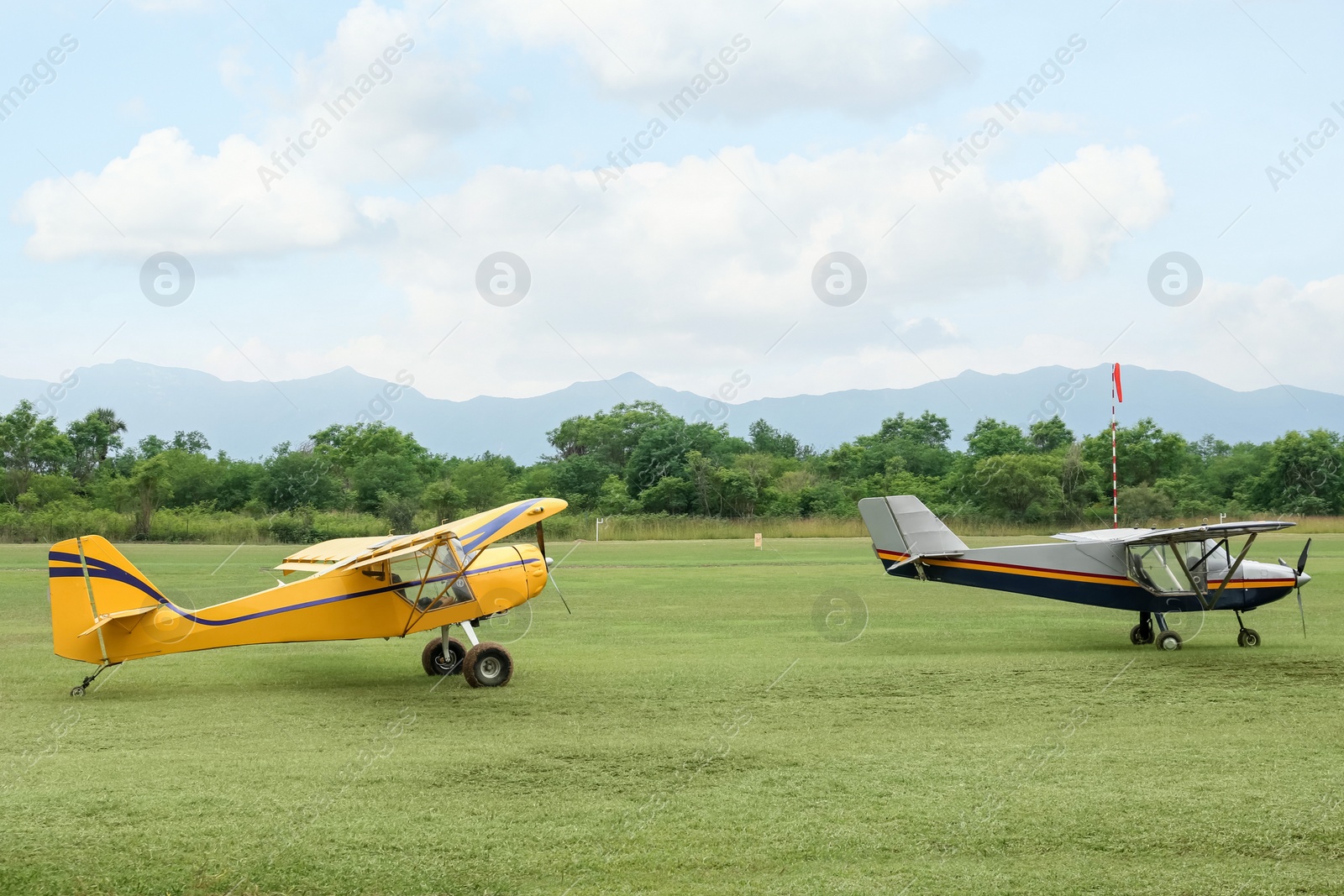 Photo of View of beautiful ultralight airplanes in field on autumn day