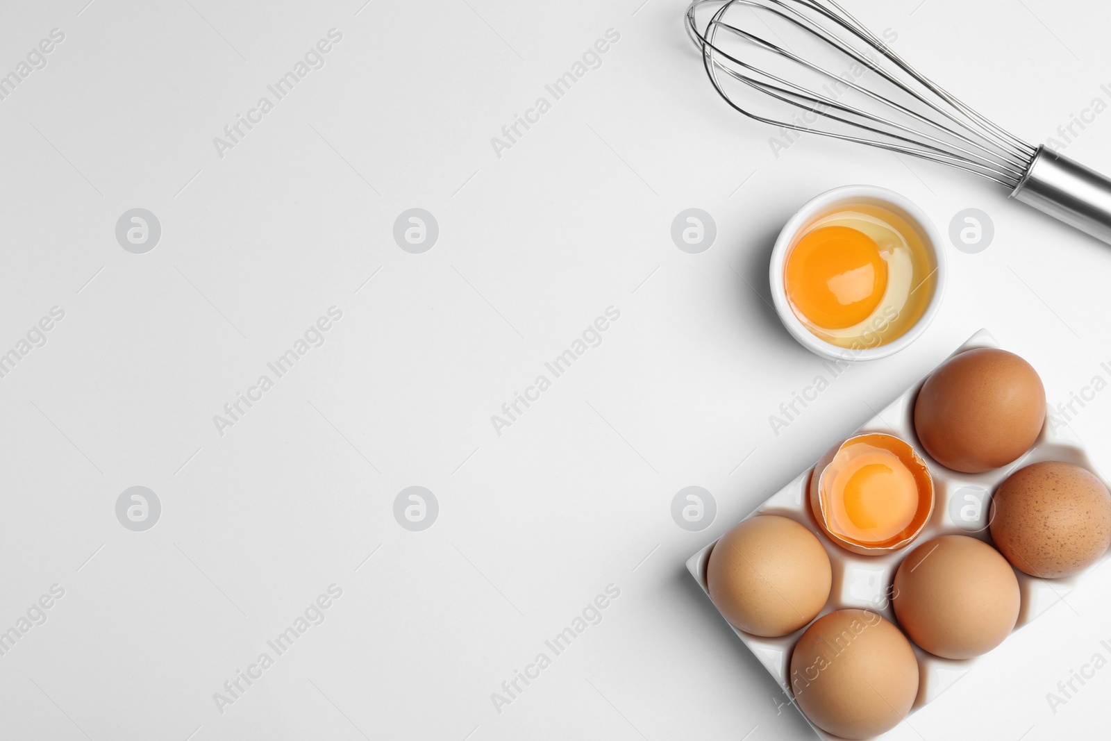 Photo of Flat lay composition with chicken eggs on white background. Space for text