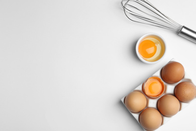 Photo of Flat lay composition with chicken eggs on white background. Space for text