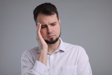 Portrait of sad man on grey background