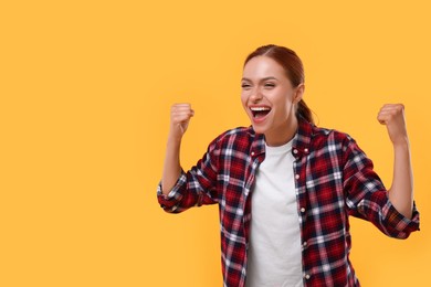 Photo of Happy fan celebrating on yellow background, space for text