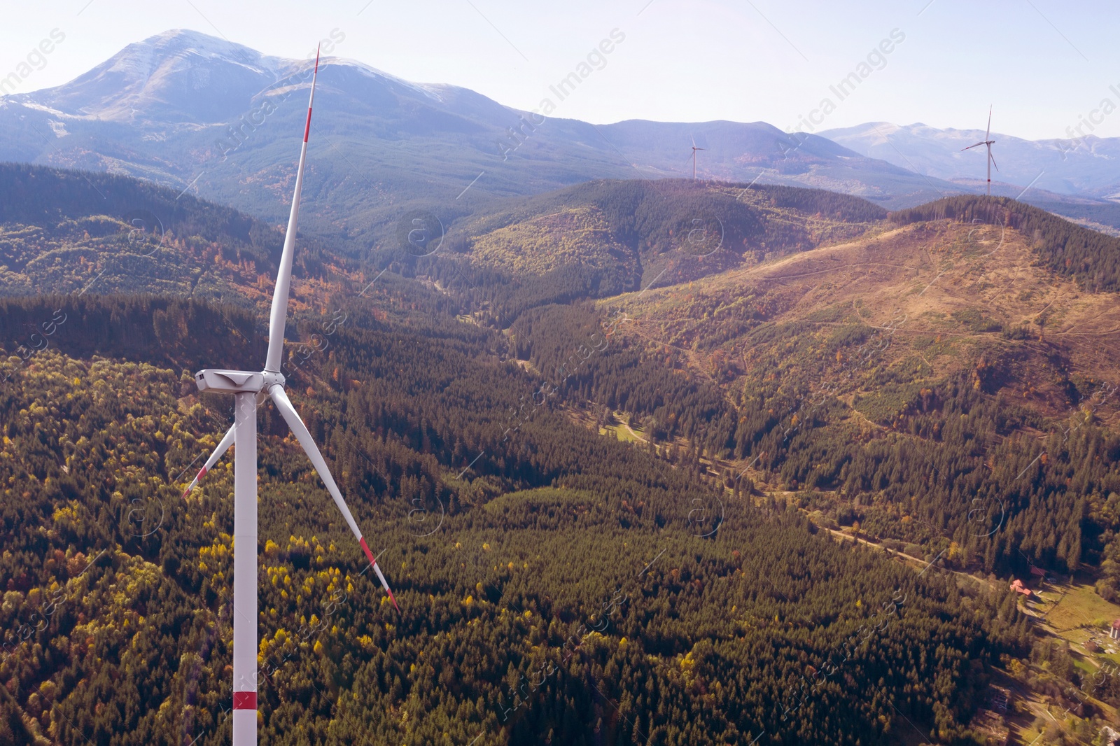 Image of Modern wind turbines in mountains. Alternative energy source