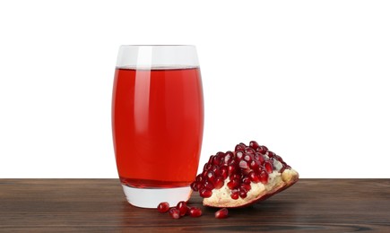 Photo of Refreshing pomegranate juice in glass and seeds on wooden table against white background
