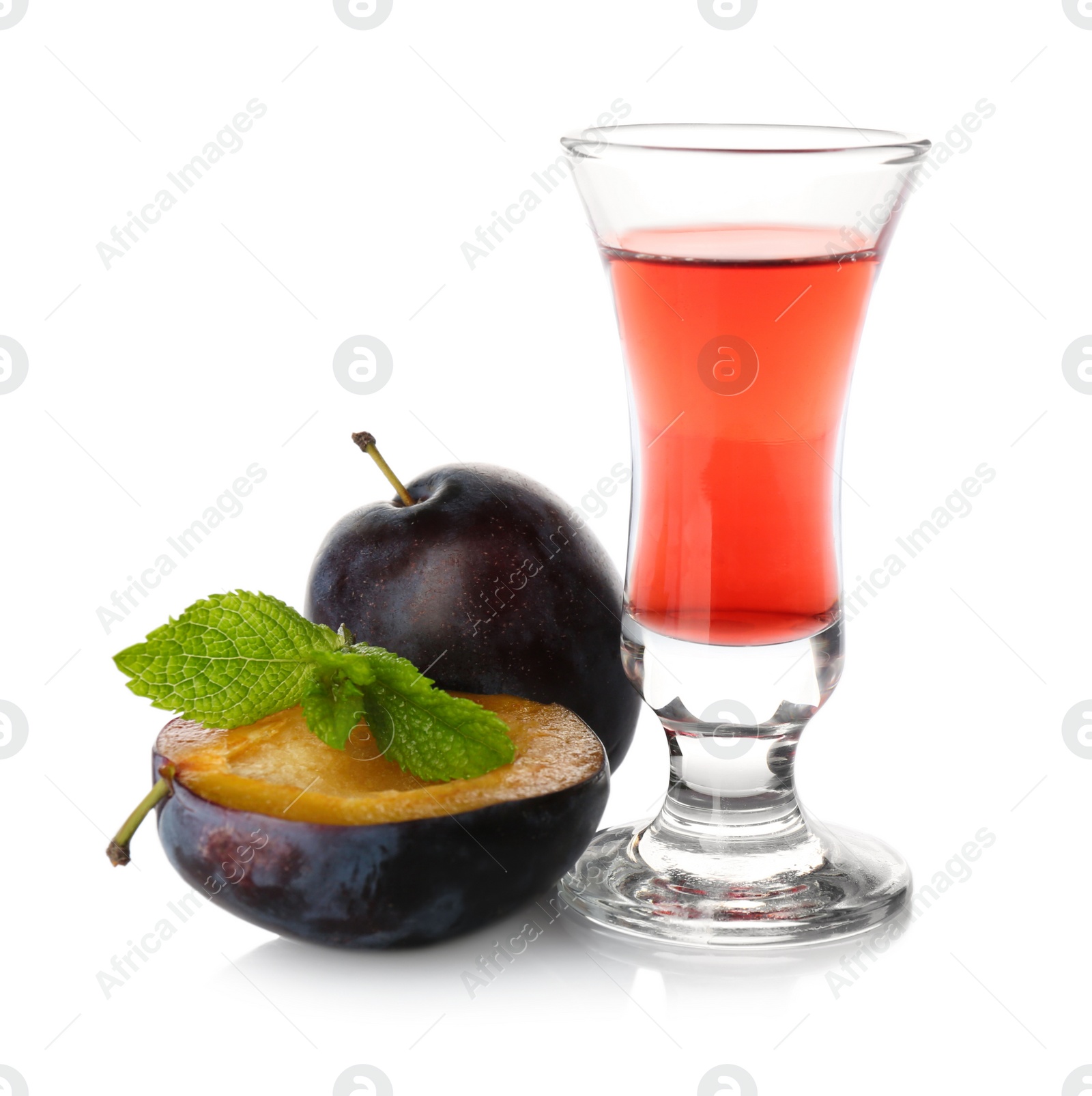 Photo of Delicious plum liquor, ripe fruits and mint on white background. Homemade strong alcoholic beverage