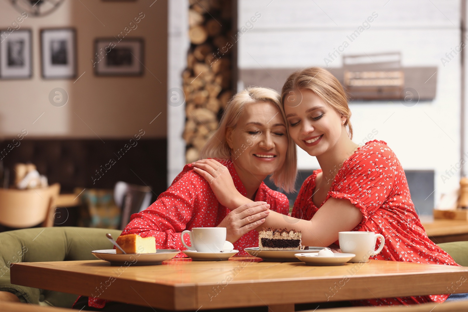 Photo of Mother and her adult daughter spending time together in cafe