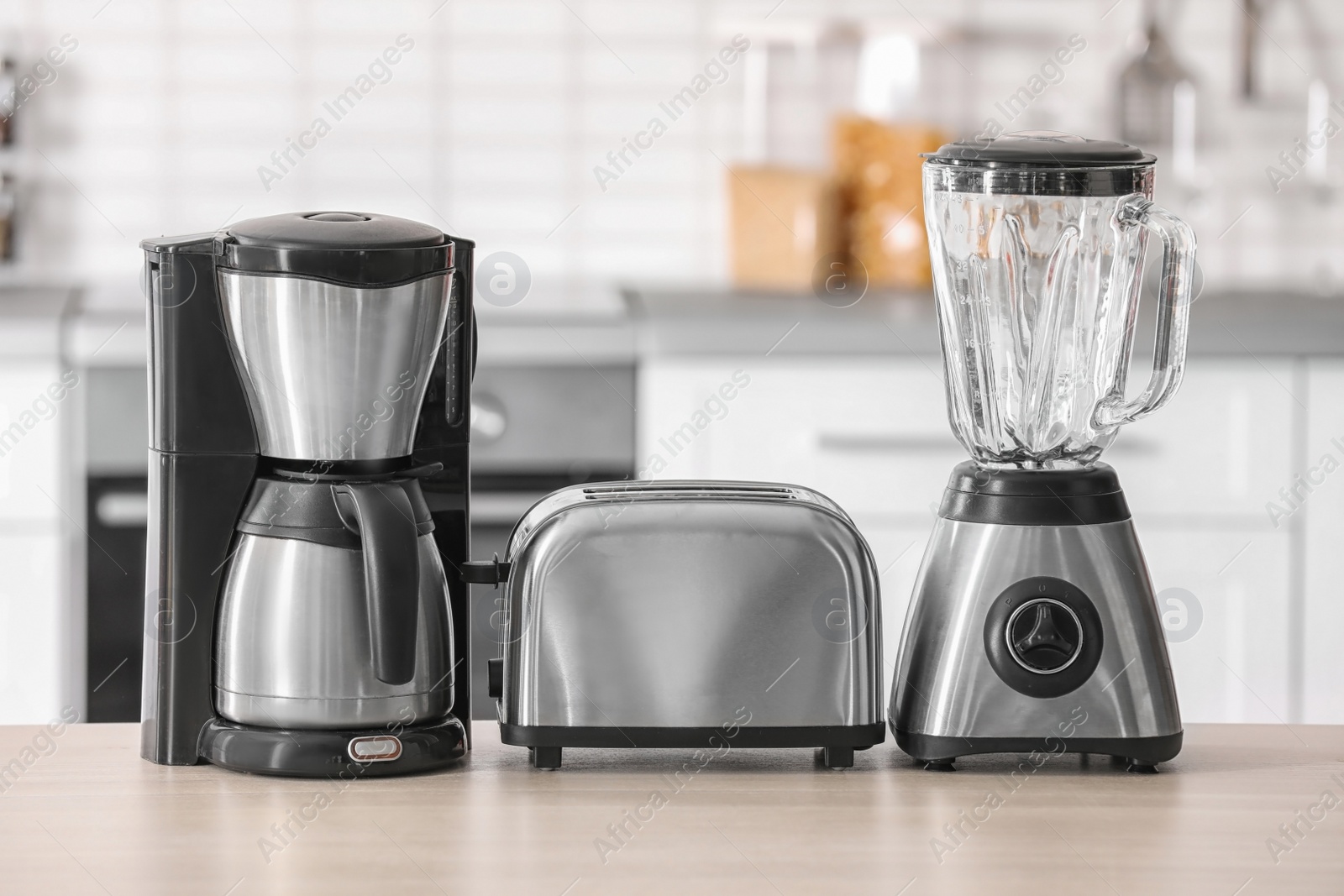 Photo of Kitchen appliances on table against blurred background