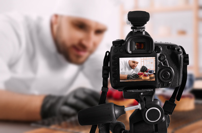 Image of Food photography. Shooting of chef decorating dessert, focus on camera