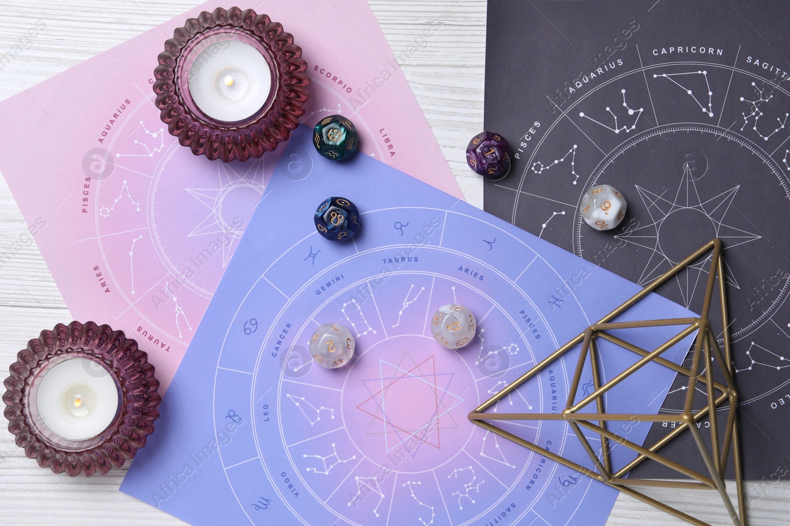 Photo of Astrology prediction. Flat lay composition with zodiac wheels on white wooden table