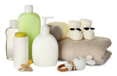 Photo of Bottles of baby cosmetic products, accessories and toy on white background