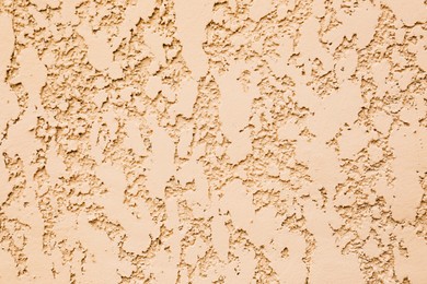 Photo of Texture of beige plaster wall as background, closeup