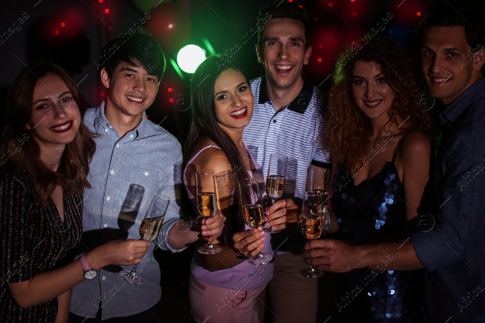 Photo of Young people celebrating birthday in nightclub