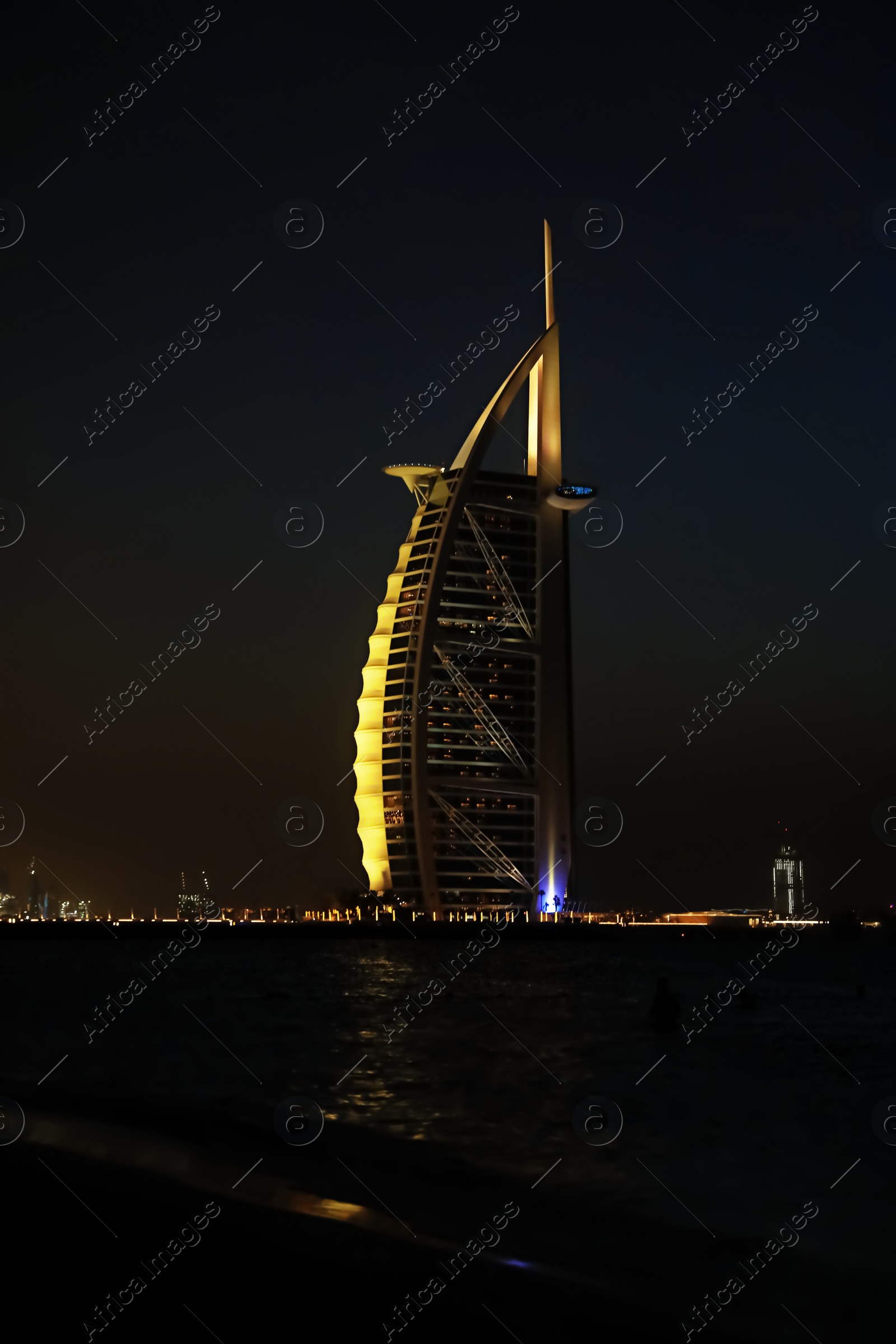 Photo of DUBAI, UNITED ARAB EMIRATES - NOVEMBER 03, 2018: Night landscape with illuminated Burj Al Arab