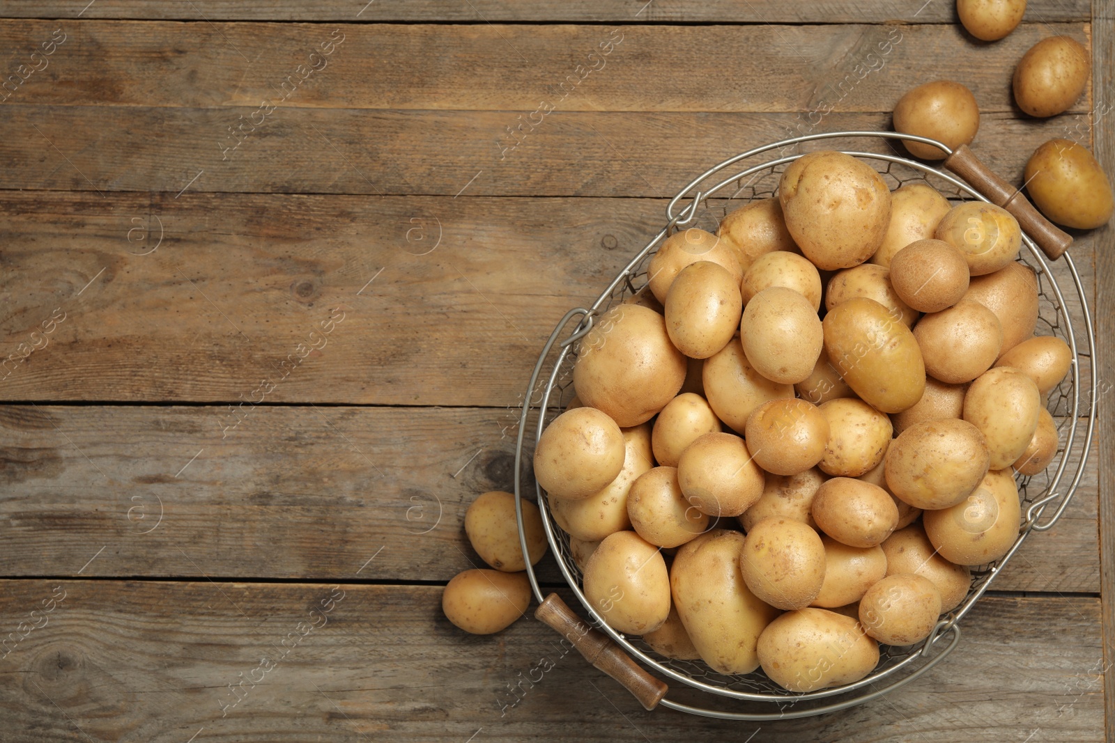 Photo of Raw fresh organic potatoes on wooden background, top view. Space for text