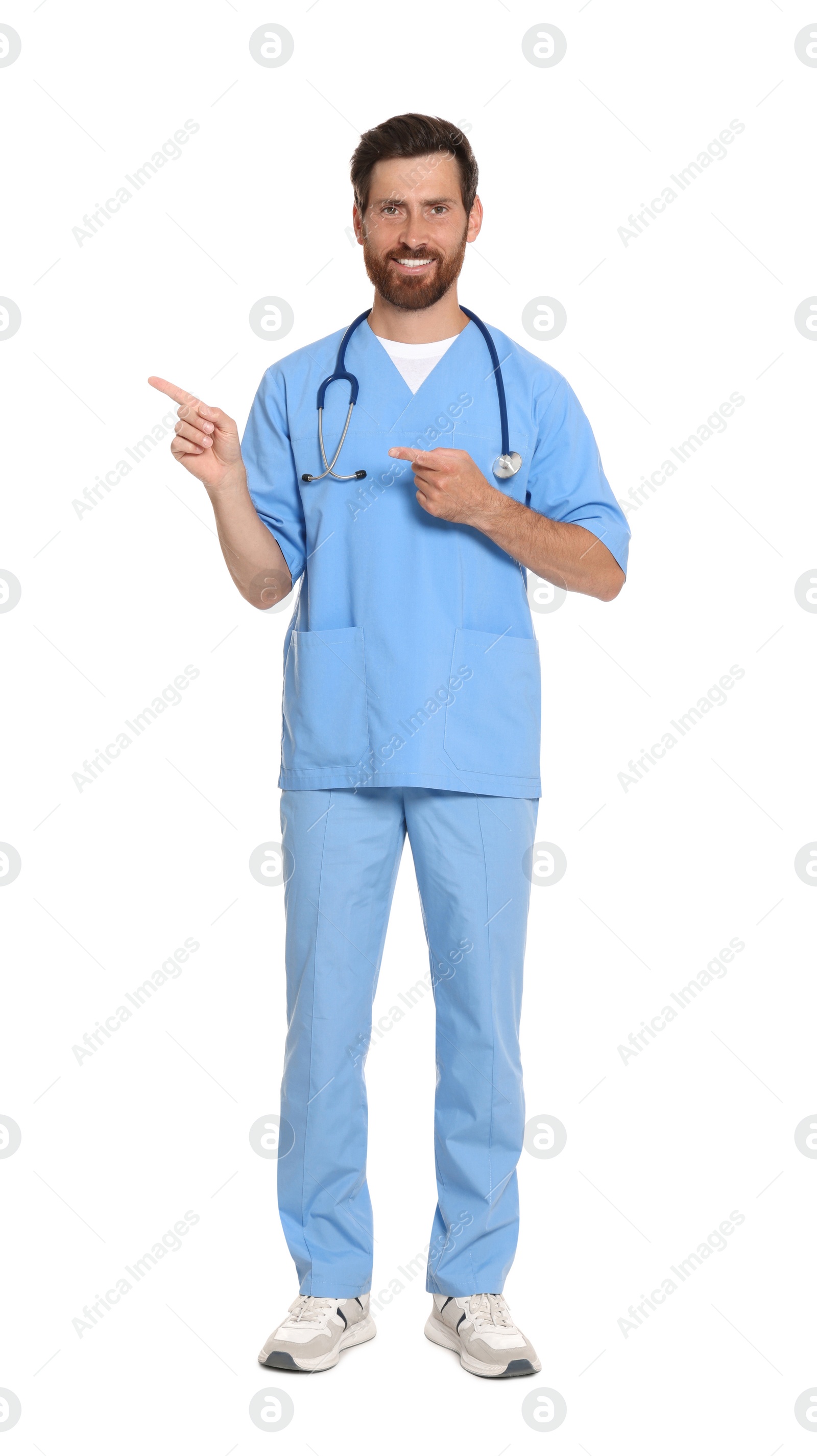 Photo of Full length portrait of doctor in scrubs on white background