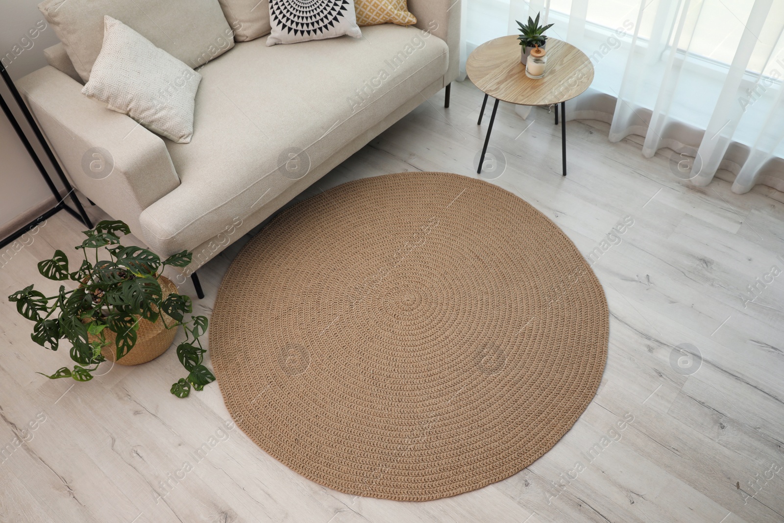 Photo of Living room interior with comfortable sofa and stylish round rug, above view
