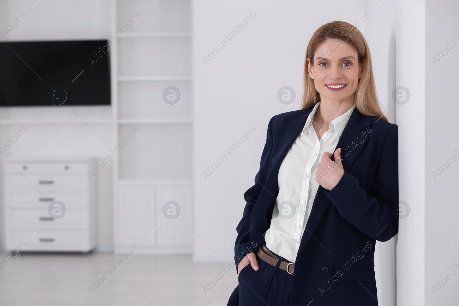 Photo of Happy real estate agent in new apartment. Space for text