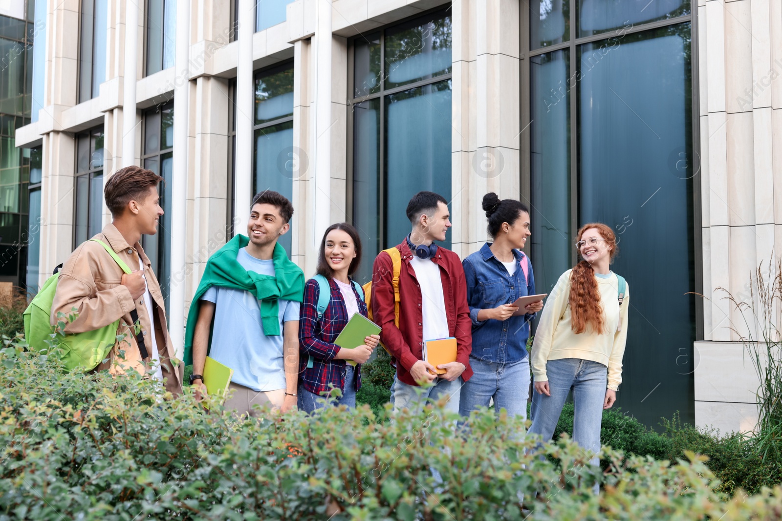 Photo of Group of happy students walking together outdoors