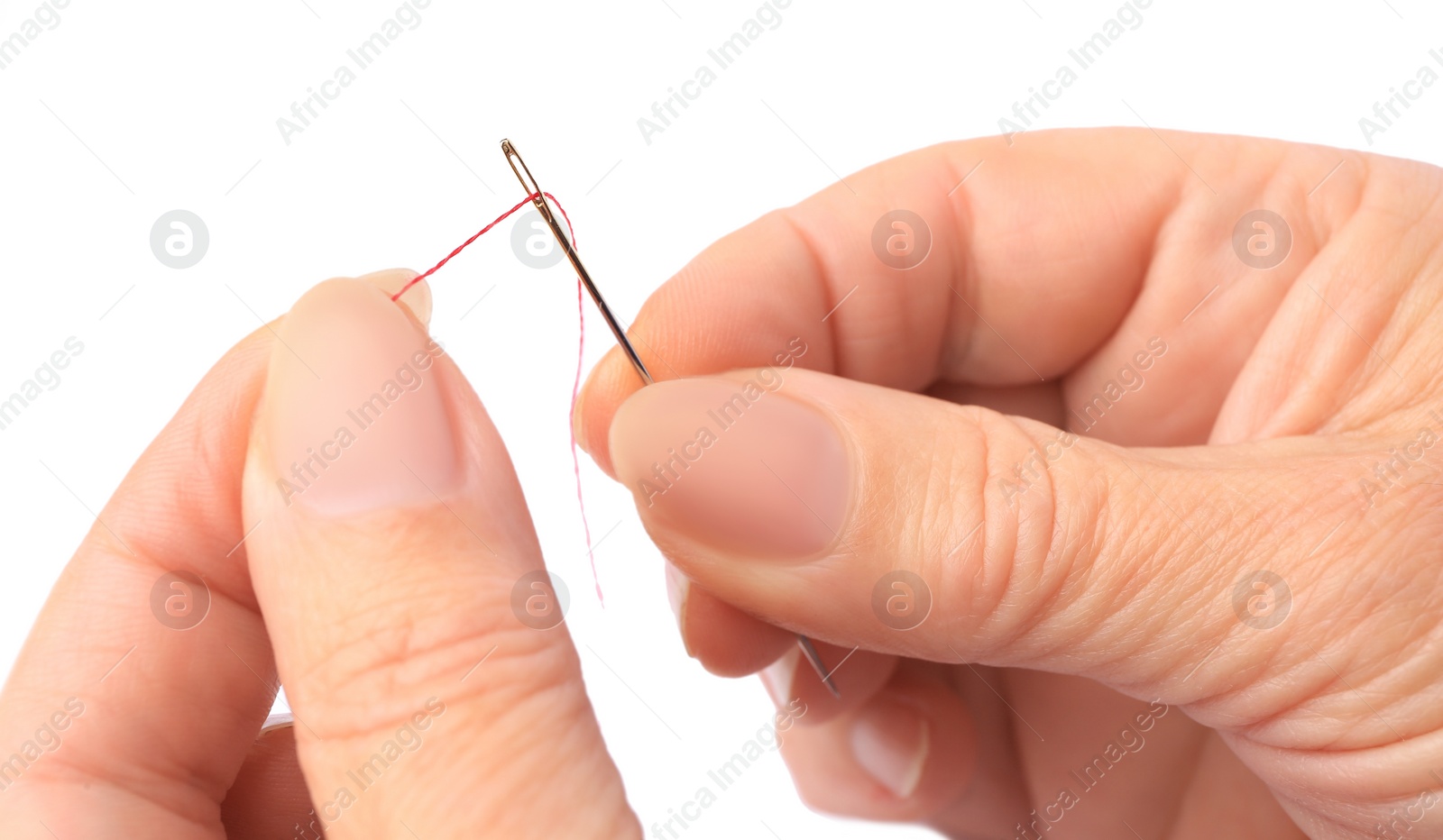 Photo of Woman threading sewing needle on white background, closeup