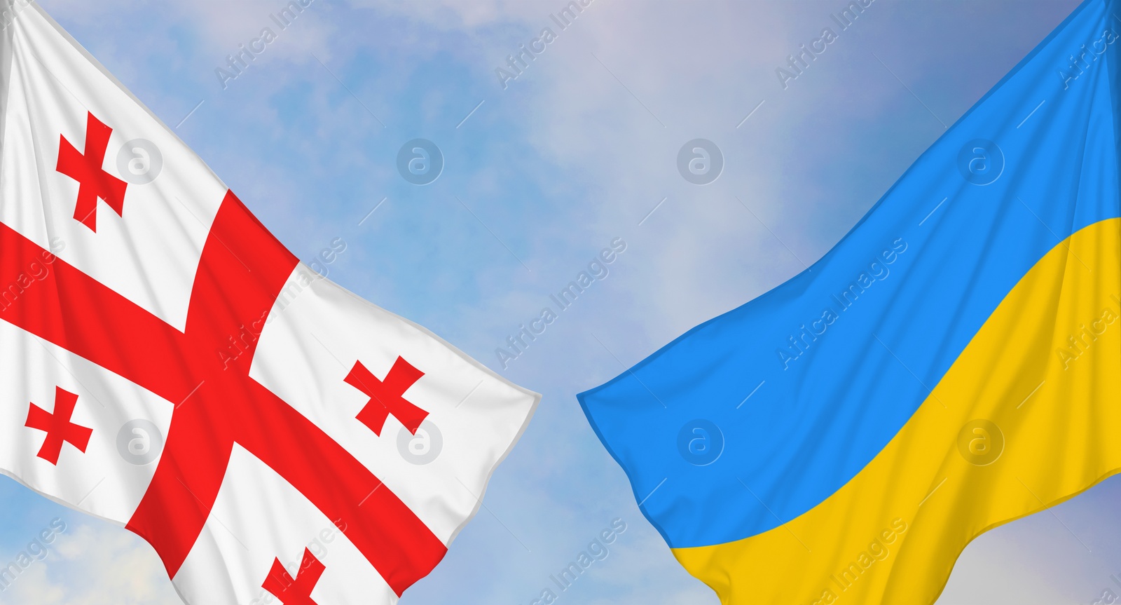 Image of National flags of Ukraine and Georgia against sky