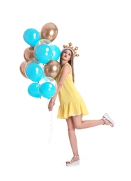Young woman with crown and air balloons on white background