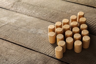 Photo of Christmas tree made of wine corks on wooden table. Space for text