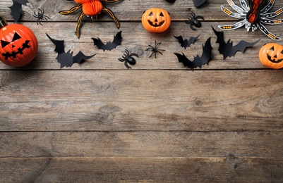 Photo of Halloween decor elements on wooden background, flat lay. Space for text