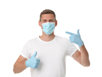 Photo of Male volunteer in mask and gloves on white background. Protective measures during coronavirus quarantine