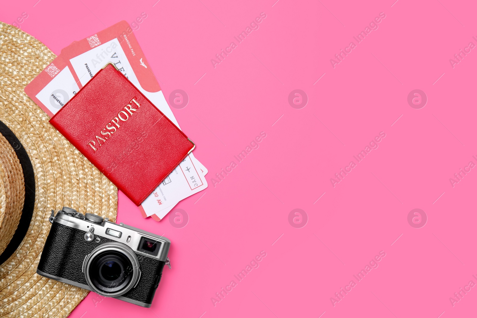 Photo of Flat lay composition with passport, tickets and travel items on pink background. Space for text