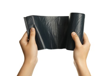 Photo of Woman holding roll of black garbage bags on white background, closeup. Cleaning supplies