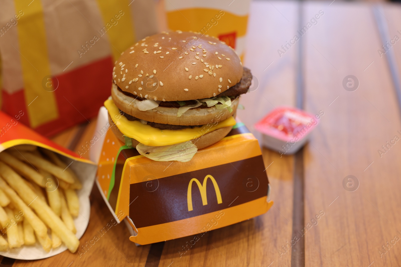 Photo of Lviv, Ukraine - October 9, 2023: McDonald's menu on wooden table in restaurant, space for text