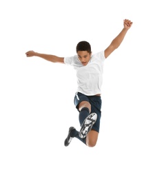 Teenage African-American boy playing football on white background