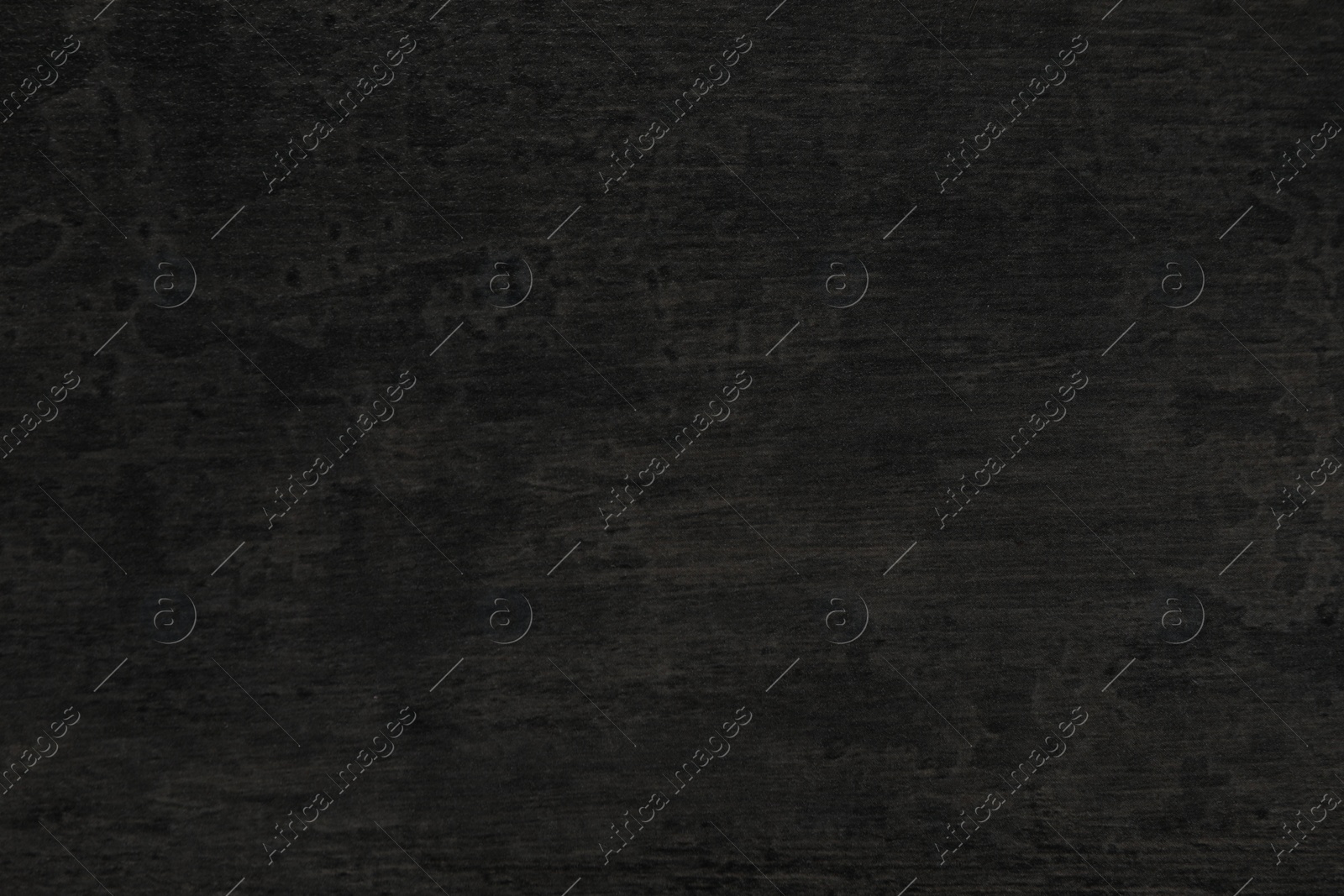 Photo of Texture of black stone surface as background, closeup