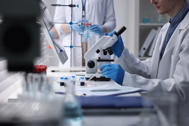 Photo of Scientists working with samples in laboratory, closeup. Medical research