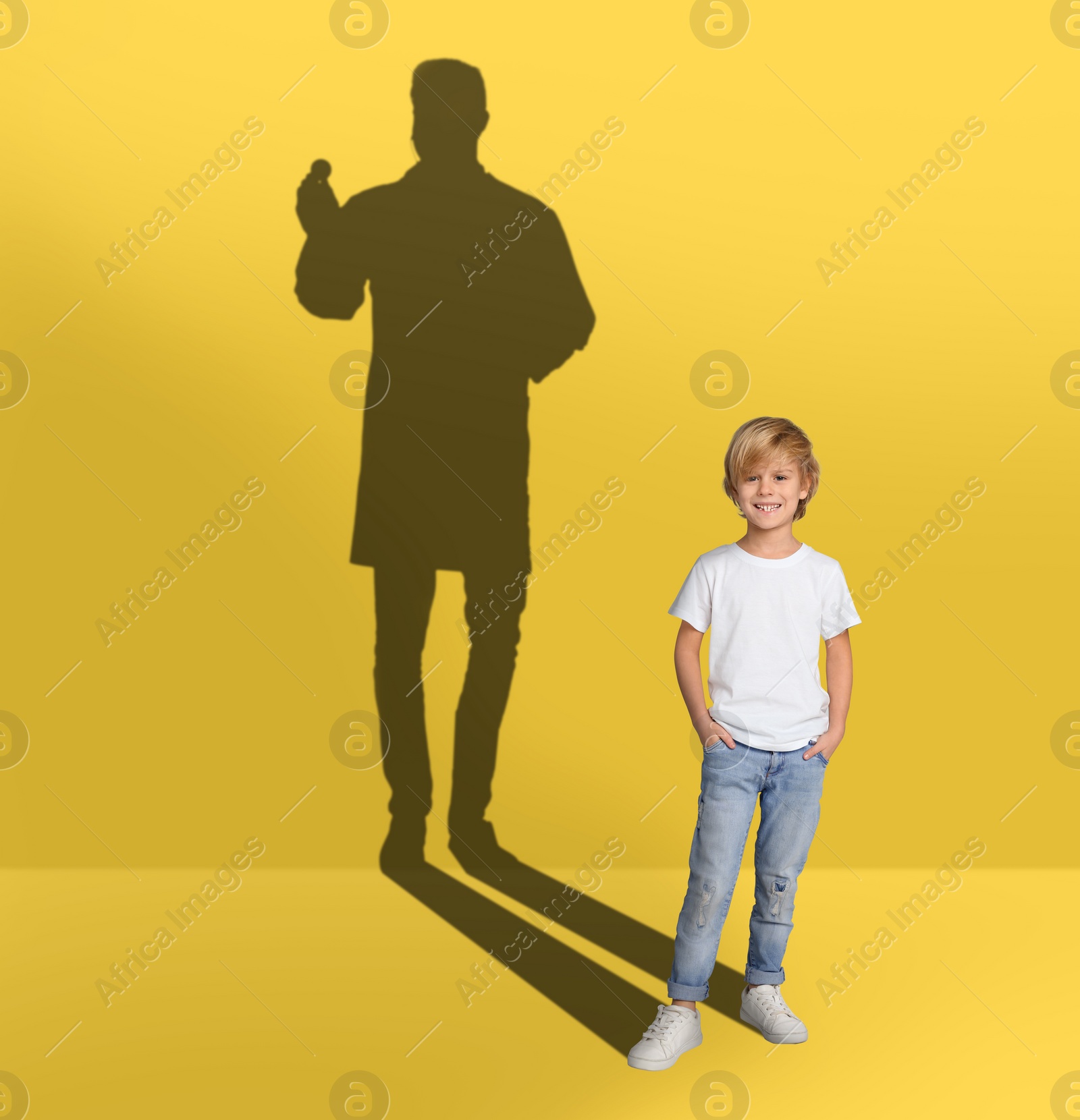 Image of Dream about future occupation. Smiling boy and silhouette of singer on yellow background