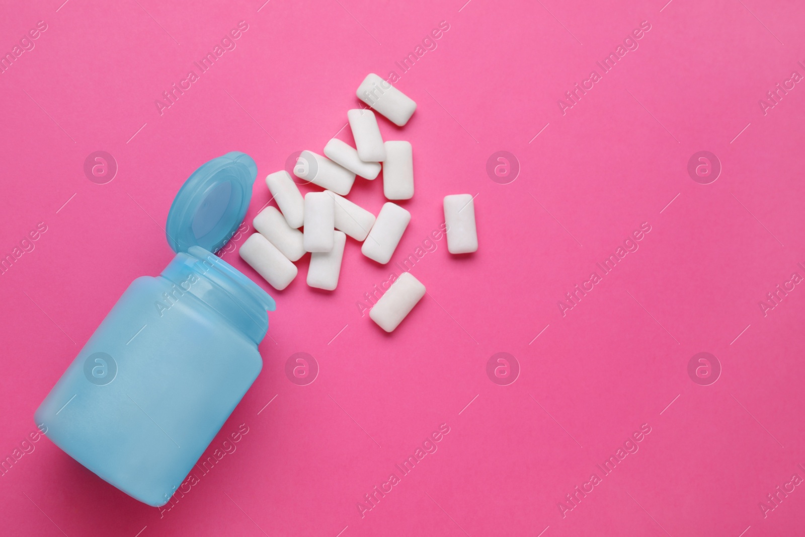 Photo of Jar with chewing gums on pink background, flat lay. Space for text