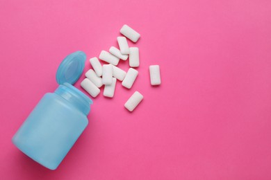 Photo of Jar with chewing gums on pink background, flat lay. Space for text