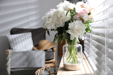 Photo of Bouquet of beautiful peony flowers on window sill indoors. Space for text