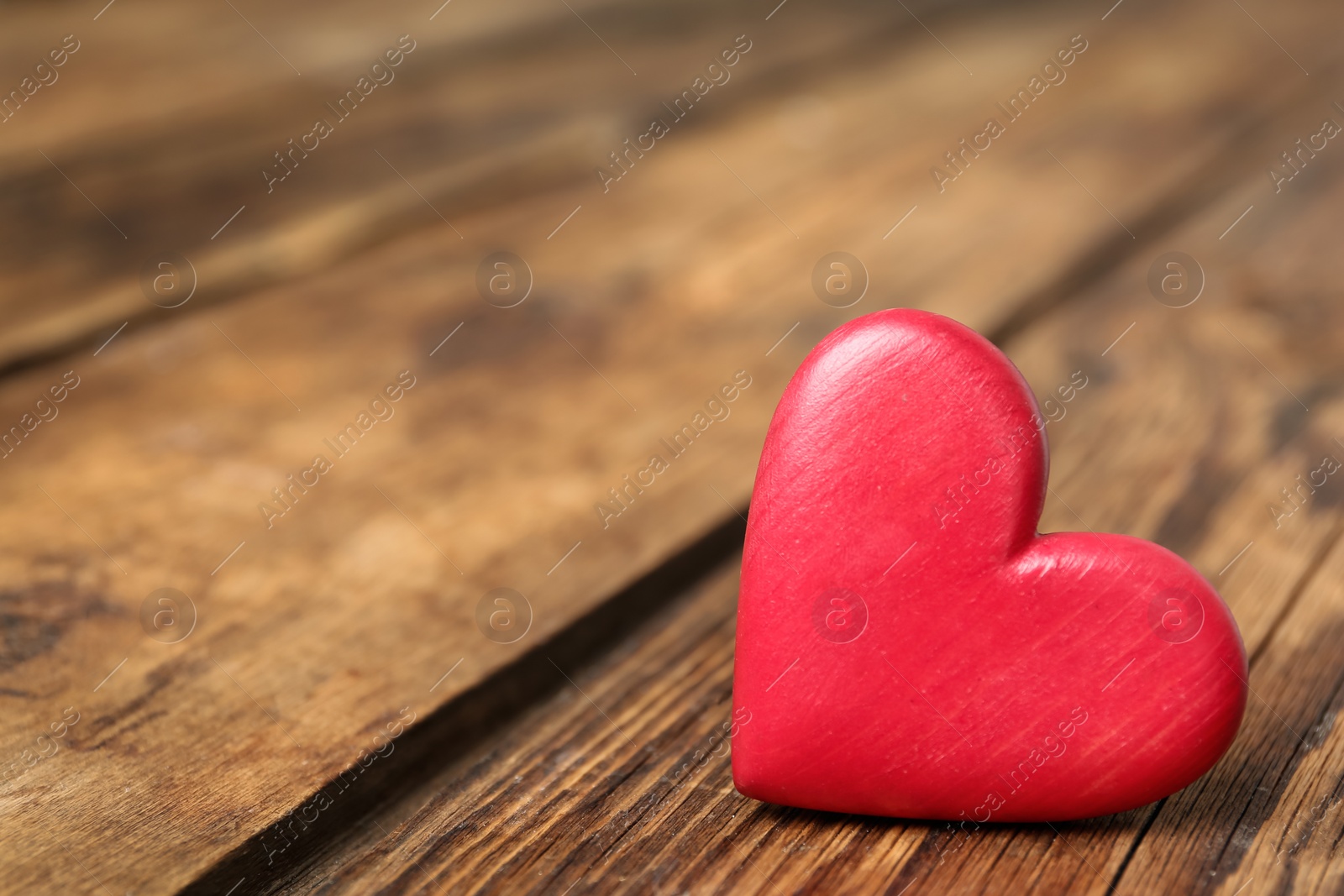 Photo of Decorative heart on wooden table, space for text. Valentine's Day