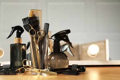 Photo of Set of hairdresser tools on table in salon, space for text