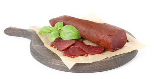 Delicious sliced dry-cured beef basturma with basil and peppercorns on white background