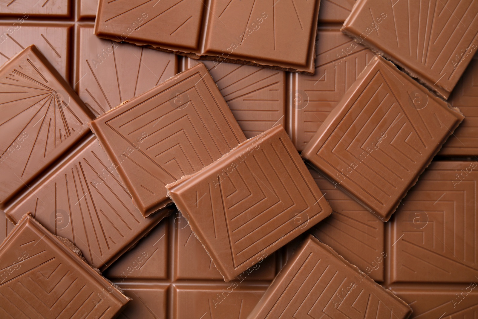 Photo of Pieces of tasty chocolate bar as background, top view