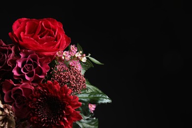 Photo of Beautiful fresh flowers on black background, space for text