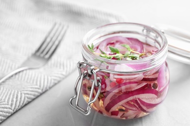 Jar of pickled onions on grey table